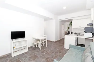 a living room with a couch and a kitchen at GuestReady - Apartamento en Benicalap in Valencia