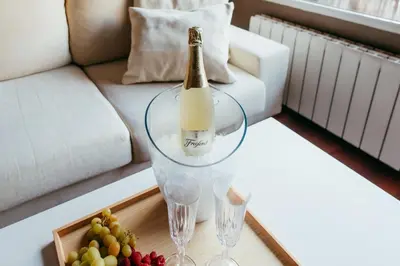 a bottle of champagne and glasses on a table in a living room at Apt Ruzafa, City Centre 10 Min, Terrace, 2 Rooms in Valencia
