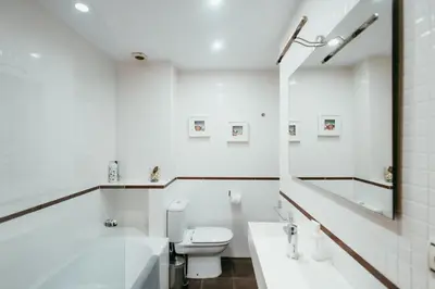 a white bathroom with a toilet and a sink at Apt Ruzafa, City Centre 10 Min, Terrace, 2 Rooms in Valencia