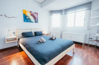 a bedroom with a large bed with two pillows on it at Apt Ruzafa, City Centre 10 Min, Terrace, 2 Rooms in Valencia