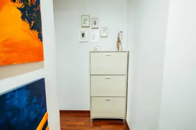 a white cabinet in a room with a painting at Apt Ruzafa, City Centre 10 Min, Terrace, 2 Rooms in Valencia