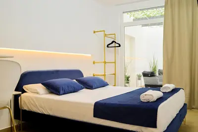 a bedroom with a bed with blue and white pillows at Forata lofts in Valencia