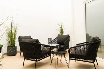a living room with chairs and a table and a couch at Forata lofts in Valencia