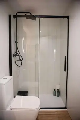 a bathroom with a toilet and a glass shower at Lofts plaza JM Orense B in Valencia