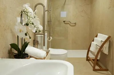 a bathroom with a toilet and a sink and a chair at Loft 9 in Valencia