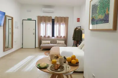 a room with a bed and a table with fruit on it at Loft 9 in Valencia