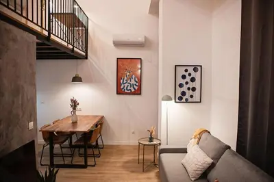a living room with a couch and a table at Lofts JM Orense D Amplio y cercano a la playa in Valencia