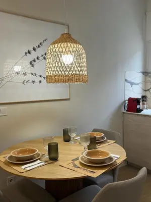 a dining room table with chairs and a chandelier at loft con wifi lavadora secadora cama agradable muy proximo valencia in Benimamet