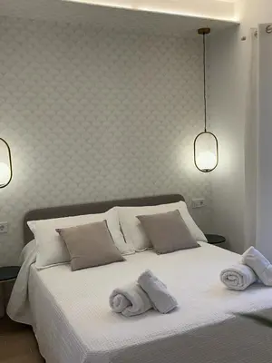 a bedroom with a white bed with towels on it at loft con wifi lavadora secadora cama agradable muy proximo valencia in Benimamet