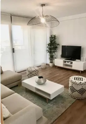 a living room with a couch and a coffee table at Espectacular apartamento en Cullera con vistas al mar in Faro de Cullera
