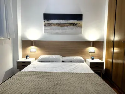 a bedroom with a large bed with two night stands at Guillem Silence in Valencia