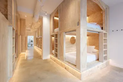 a hallway with a room filled with bunk beds at Colo Colo Hostel Valencia - Single Private Beds in Valencia