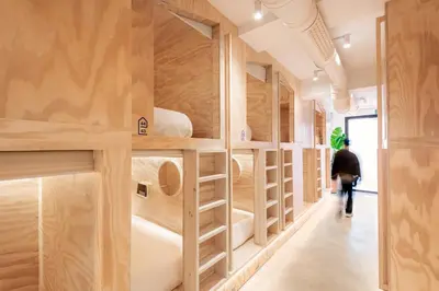 a room filled with lots of wooden bunk beds at Colo Colo Hostel Valencia - Single Private Beds in Valencia