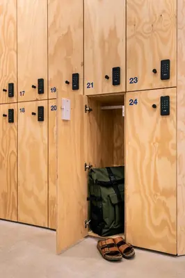 a row of lockers with a green bag and shoes at Colo Colo Hostel Valencia - Single Private Beds in Valencia