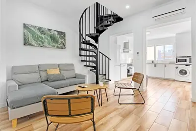 a living room with a couch and a table and chairs at Apartamento 4 habitaciones y 2 baños in Puerto de Sagunto
