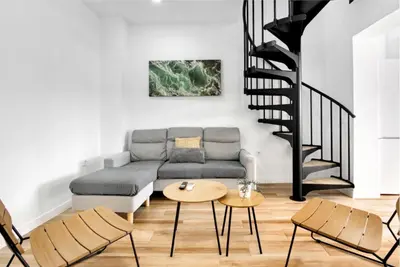 a living room with a couch and a table at Apartamento 4 habitaciones y 2 baños in Puerto de Sagunto