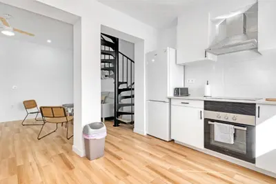 a kitchen with white appliances and a dining room at Apartamento 4 habitaciones y 2 baños in Puerto de Sagunto
