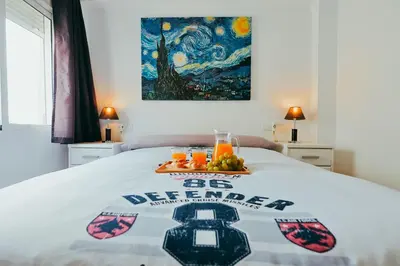 a bed with a sign on it with fruit on it at Apt Cabanyal, Beach 8 Min, Terrace, Smart TV in Valencia