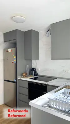 a kitchen with a stainless steel refrigerator and gray cabinets at Apt Cabanyal, Beach 8 Min, Terrace, Smart TV in Valencia
