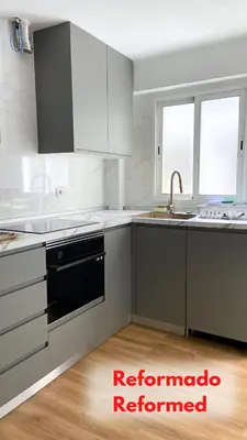 a kitchen with white cabinets and a black dishwasher at Apt Cabanyal, Beach 8 Min, Terrace, Smart TV in Valencia