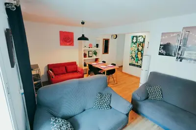 a living room with two blue chairs and a table at Apt Cabanyal, Beach 8 Min, Terrace, Smart TV in Valencia