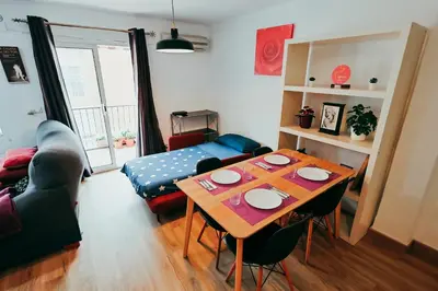 a living room with a table and a couch at Apt Cabanyal, Beach 8 Min, Terrace, Smart TV in Valencia