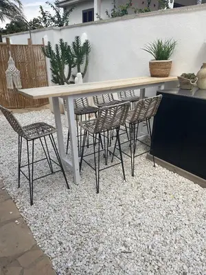 a white table and chairs on a gravel patio at CASA Silvestre in La Eliana