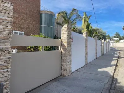 a white fence in front of a building at CASA Silvestre in La Eliana