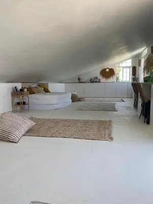 a bedroom with a bed and two rugs on the floor at CASA Silvestre in La Eliana