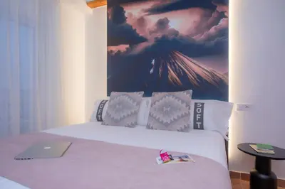 a bedroom with a bed with a laptop on it at Casual Natura Valencia in Valencia