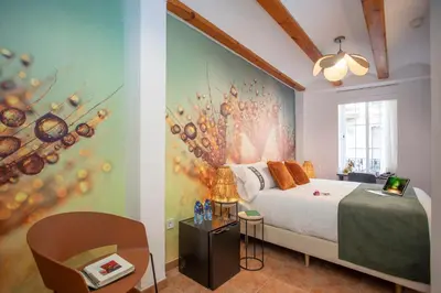 a bedroom with a bed and a wall with a painting at Casual Natura Valencia in Valencia