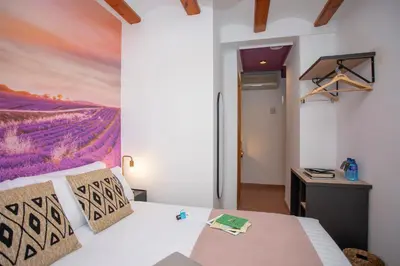 a bedroom with a bed with a painting on the wall at Casual Natura Valencia in Valencia