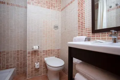 a bathroom with a toilet and a sink at Casual Natura Valencia in Valencia