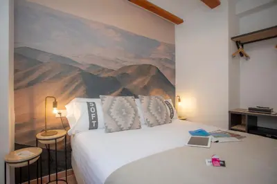 a bedroom with a bed with a painting on the wall at Casual Natura Valencia in Valencia