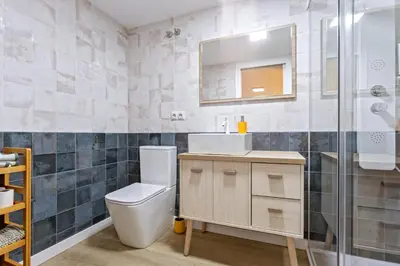 a bathroom with a toilet and a sink and a shower at Apartamento Beniloft - Housevanlive in Valencia
