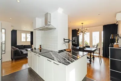 a kitchen with white cabinets and a black counter top at GuestReady - Elegant Retreat in Valencia in Valencia