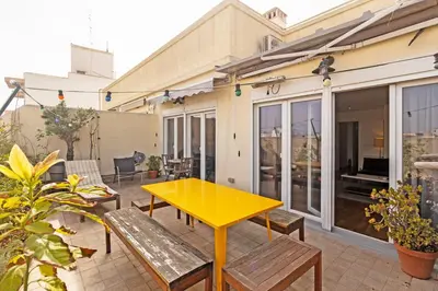 a yellow table on a patio with benches at GuestReady - Elegant Retreat in Valencia in Valencia