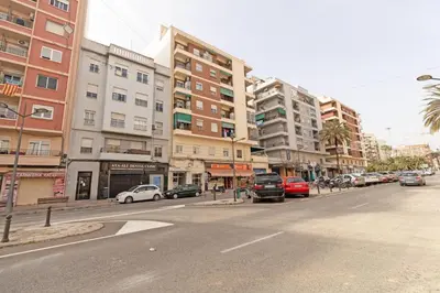 a street with cars parked on a city street with tall buildings at GuestReady - Elegant Retreat in Valencia in Valencia