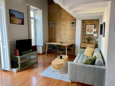 a living room with a couch and a table at GuestReady - Charming stay in the Heart of Russafa in Valencia