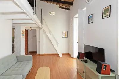 a living room with a couch and a tv at GuestReady - Charming stay in the Heart of Russafa in Valencia