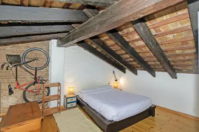a bedroom with a bed and a bicycle on the wall at GuestReady - Charming stay in the Heart of Russafa in Valencia