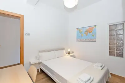 a white bedroom with a bed and a window at GuestReady - Valencia's Sushine Terrace in Valencia