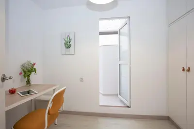 a white room with a desk and a chair at GuestReady - A joyful stay in Poblats Marítims in Valencia