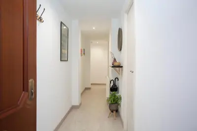 a hallway with a door and a plant on a stool at GuestReady - A joyful stay in Poblats Marítims in Valencia