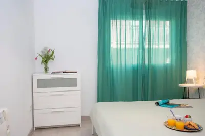 a bedroom with a bed and a table with a plate of food at GuestReady - A joyful stay in Poblats Marítims in Valencia