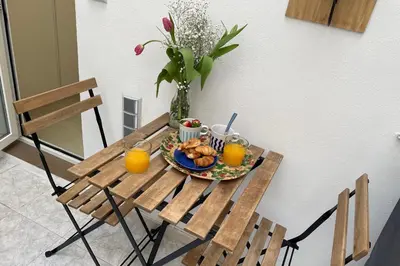 a table with a plate of food and orange juice at GuestReady - A joyful stay in Poblats Marítims in Valencia