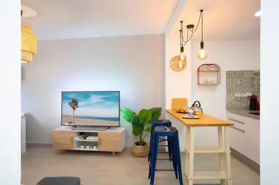 a living room with a table and a tv at GuestReady - A joyful stay in Poblats Marítims in Valencia