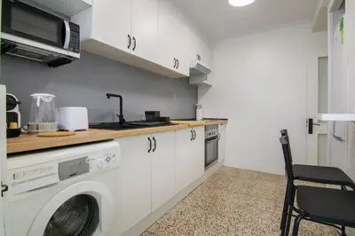 a kitchen with a washing machine and a microwave at GuestReady - Tranquil Haven in Canyamelar in Valencia