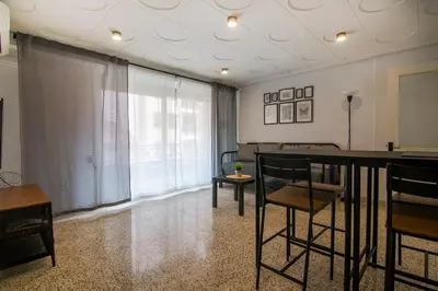 a living room with a table and chairs at GuestReady - Tranquil Haven in Canyamelar in Valencia