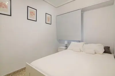 a white bed with white pillows in a bedroom at GuestReady - Tranquil Haven in Canyamelar in Valencia